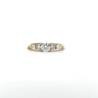 Classic Three Stone Diamond Ring with Round Center and Baguette Side Stones